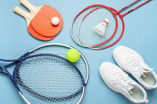 Tennis paddle rackets with ball on grey background. Summer sport activity concept. Top view