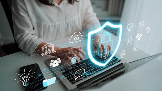 Businesswoman working on laptop with digital security icons and data protection symbols in modern office setting. Entropy.