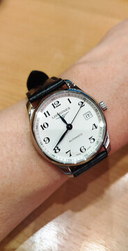 BANGKOK, THAILAND - JUNE 27 : Longines Master Collection, numeric marker, white dial in stainless steel case with alligator strap wear on wrist in Bangkok, Thailand, on June 27, 2026.