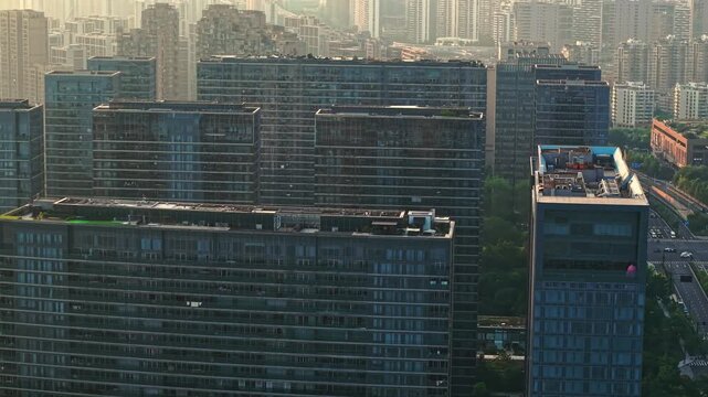 Dense urban landscape featuring high rise apartment buildings in Hangzhou, China during daytime with soft light and distant freeway view