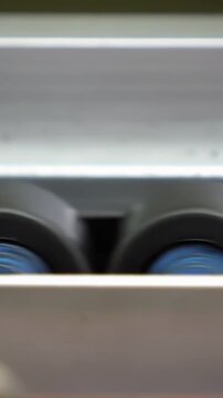 Extreme Close Up Of Industrial Roller Wheels Spinning Fast on Conveyor - 4K Vertical