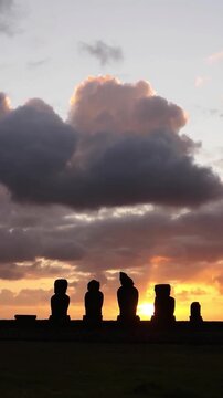 Moai Statues Silhouette Against Dramatic Ocean Sunset - 4K Vertical