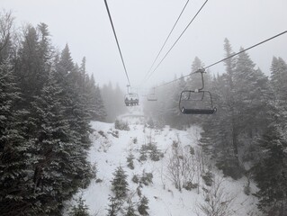 Skiing in winter - chairlift gondola and ski slopes for skiing and snowboarding  between trees on frosty day with beautiful views in  mountains © joi