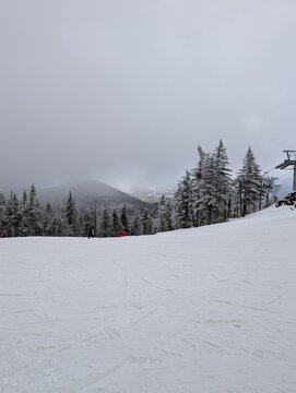 The mountain slopes are covered in snow&mdash;a white road, snow-laden fir trees; a beautiful winter in the mountains. Canada, Ontario.