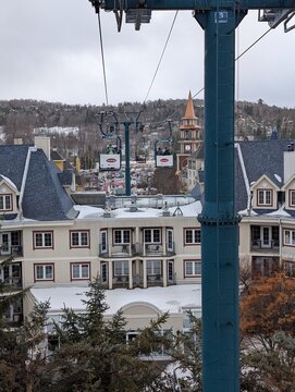 Skiing in winter - chairlift gondola and ski slopes for skiing and snowboarding  between trees on frosty day with beautiful views in  mountains