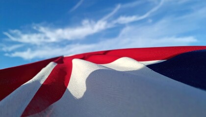 Vast American Flag Billowing Against a Bright Blue Sky.