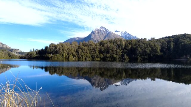 Motion Lapse timelapse of Bariloche Mountains, Snow-Capped Peaks, still water and Lakes with Moving Clouds, Patagonia, Argentina. Nahuel Huapi Lake