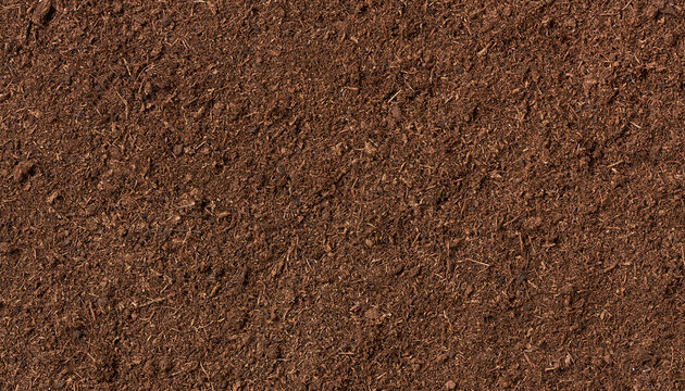 A close-up view of rich, dark brown soil with visible texture, suitable for gardening or construction themes