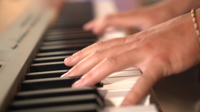 Hand Playing Piano Keys in Soft Natural Light