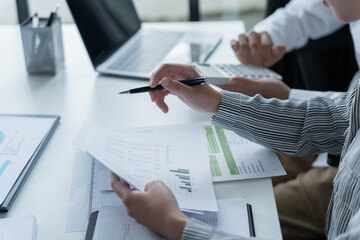 Fototapeta premium Two Asian business people working together in an office