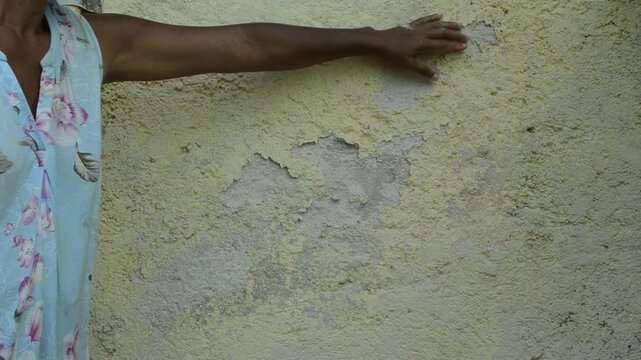 A decaying wall that crumbles at the touch or brush of a hand.