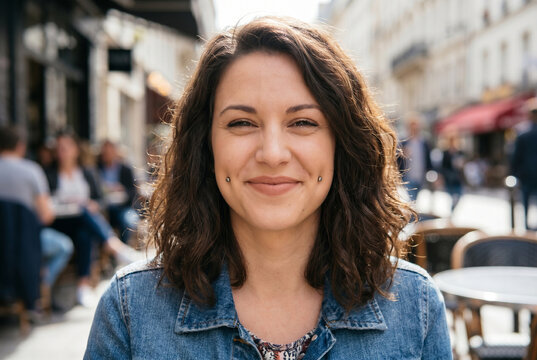 Young woman smiling with dimples in a cafe outdoors  