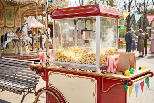 Vintage popcorn machine cart with popcorn at outdoor carnival  