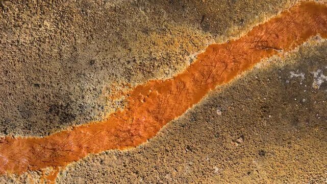 swimming treat in Iron Oxide hot spring stream of copper metal volcanic eruption from mountain natural orange red colorful liquid flow vivid spa health skin care water pool rock boiling Jermuk resort