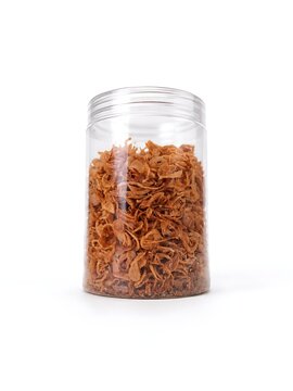 Fried shallot slices are in a jar , white background