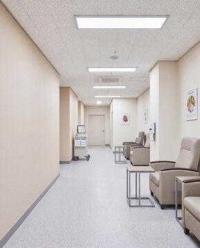 Hospital outpatient corridor with waiting chairs and medical equipment