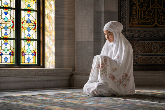 Young Indonesian Woman Praying Alone in Mukena at Quiet Mosque