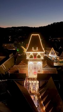 Night View Of Capivari Village In Campos Do Jordao In Sao Paulo Brazil. Illuminated Ferris Wheel. Downtown Cityscape. European Architecture. Capivari Village In Campos Do Jordao In Sao Paulo Brazil. 