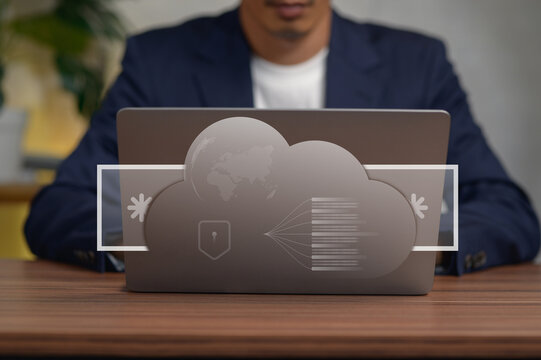 Business Professional Using Cloud Computing Technology on Laptop in Office Setting