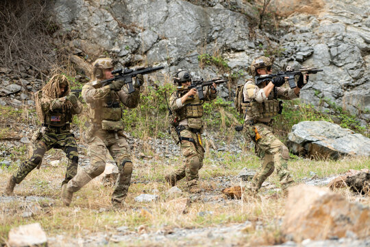 Special operations team advances through rugged terrain during a tactical patrol exercise