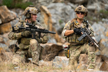 Fototapeta premium Military personnel communicate and coordinate during a tactical field operation