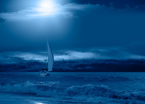 Sailboat on ocean navigating stormy waterand stormy black clouds waves crashing vigorously against hull