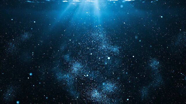 海中で水面から差し込む美しい光のカーテンに照らされた無数の粒子がキラキラと漂う背景動画