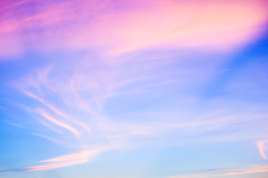 Bright Blue Sky with Soft Pink Twilight Wispy Clouds