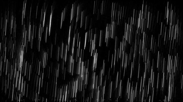 Heavy rain falling in front of dark background