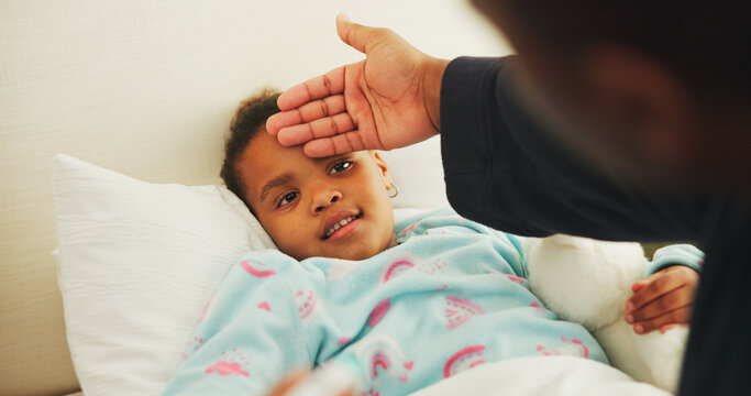 Fever, hand and parent with child in bed of family home for sick, illness and influenza symptom. Medical, support or cold season with kid and person in apartment bedroom for help and healthcare