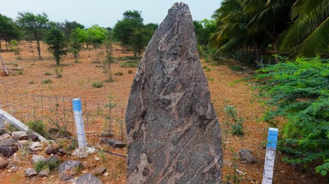 Drone shot of Kodumanal megalithic excavation site, Tamil Nadu, showing ancient menhir stones and burial cists on arid red soil, one of South India's oldest archaeological discoveries.