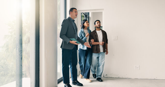 Couple, relocation and tour with realtor in new home for opportunity, sale or viewing. People, mortgage loan and property buyer with bond in real estate space for development, inspection or purchase