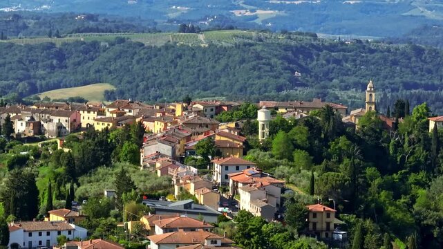 Telephoto drone shot of the Marcialla town, sunny, summer day in Tuscany, Italy