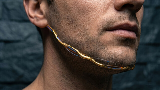 Close up of male face with liquid gold jawline and embedded glowing fiber optic threads concept