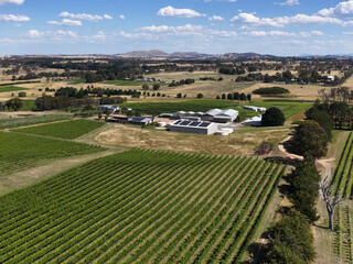 Fototapeta premium Aerial View of Lush Green Vineyards and Rural Farm Buildings in Canberra