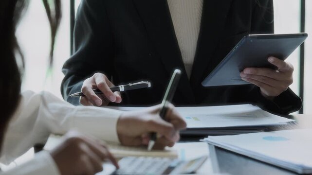 Financier team collaborates on project details in finance meeting session