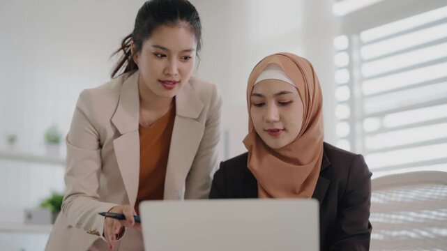 Multiethnic coworkers working together, Asian muslim