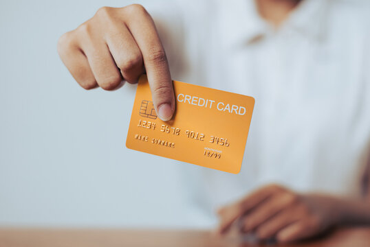 Woman holding a credit card emphasizing the concept of payment transactions in modern shopping