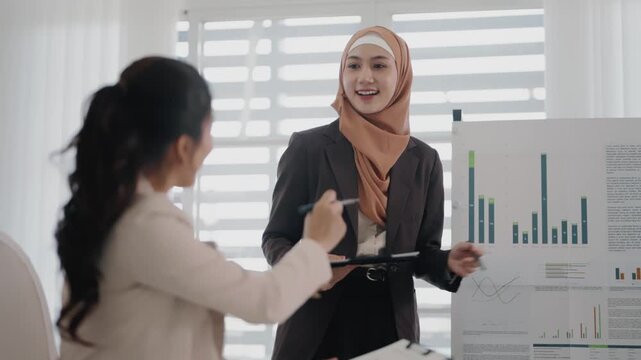 Multiethnic coworkers working together, Asian muslim