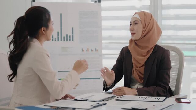 Multiethnic coworkers working together, Asian muslim