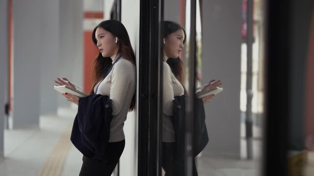Business woman takes notes on paper notebook outdoors in city