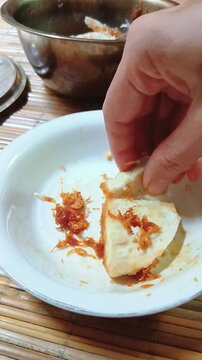 Enjoying Steamed Taro with Grated Coconut Traditional Snack