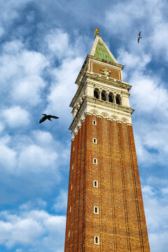 St Mark's belfry, Campanile di San Marco in Venice, Italy, with sky and birds in backgrouind