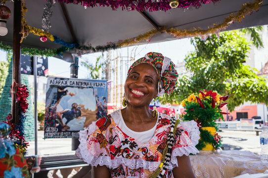 Baiana woman in traditional white dress and colorful beads, Salvador, Bahia, Brazil
