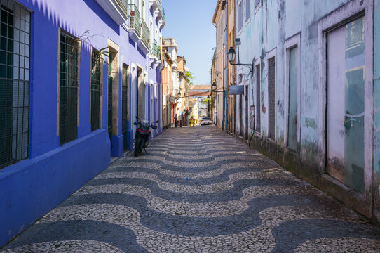 Cobblestone street with a wave pattern and colorful colonial buildings, Salvador, Bahia, Brazil