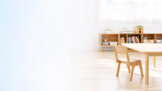 Empty nursery caregiver chair in bright nursery room, childcare worker shortage and waiting list and recruitment concept banner with copy space