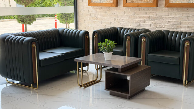 Modern hotel lobby with elegant black leather sofas, marble coffee table and contemporary interior design. Luxury hospitality lounge for guests in a premium resort or boutique hotel.