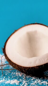 Coconut Falling in Slow Motion Dynamic Tropical Fruit Drop on Blue Background