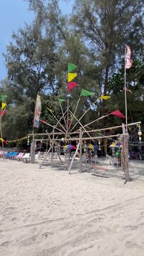 Wooden installation with flags on a public beach