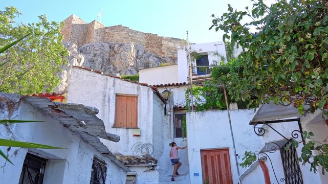 Tourist walking up stairs in Anafiotika district in Athens, Greece
